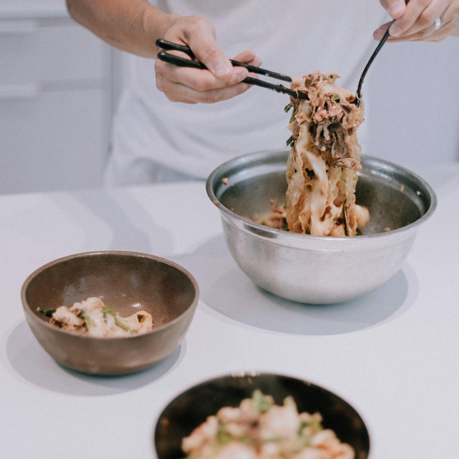 Diverse group of community members sharing a meal together, showcasing the social bonds formed through collaborative cooking